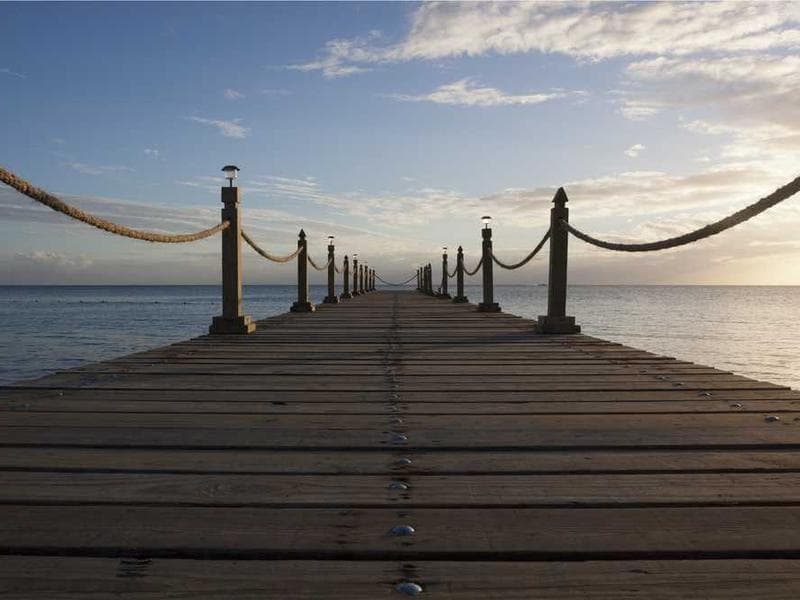 A person sitting alone on a subway, captured in black and white