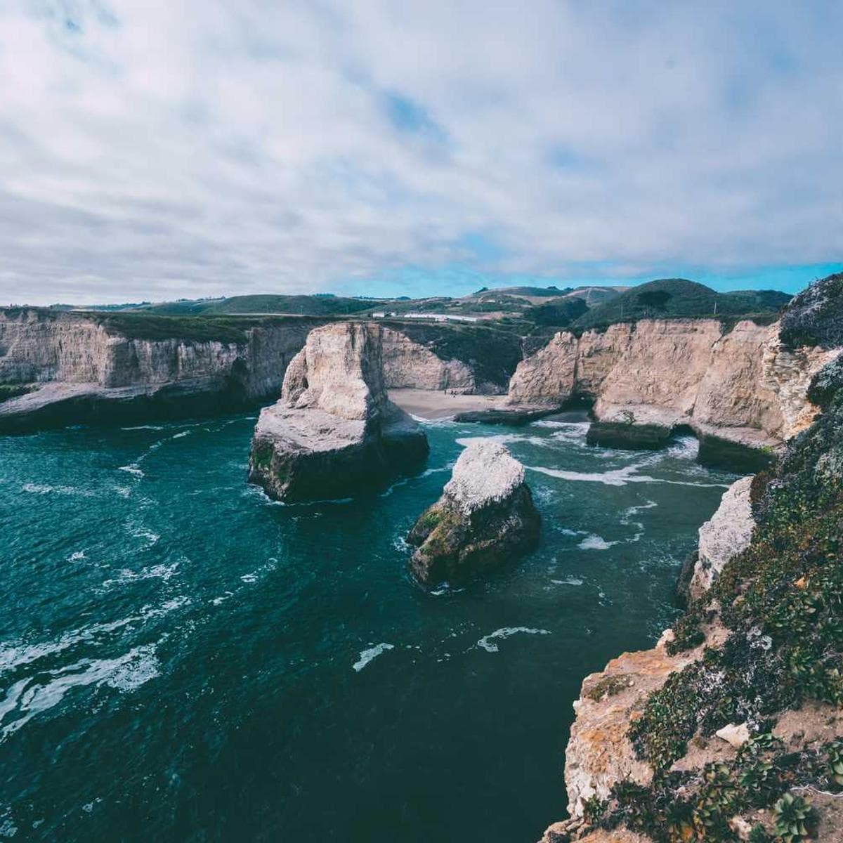 A dramatic black and white portrait of an elderly man with deep wrinkles