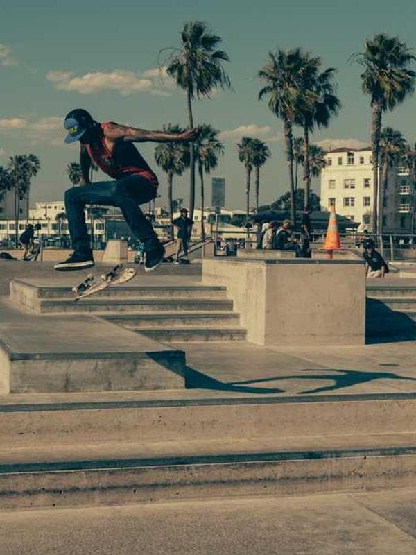 A person wearing a 70s style patterned shirt and bell bottoms